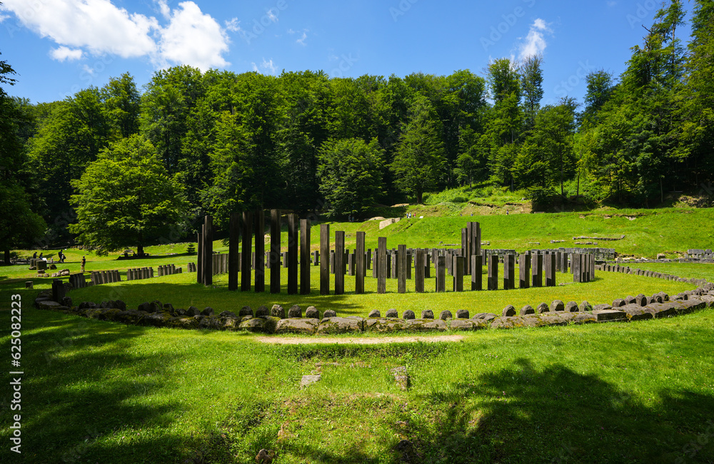 Sarmizegetusa Regia historical landmark in Romania. Wide angle photo during a sunny day in the middle of green forest Orastiei Mountains. Landmarks of Romania.