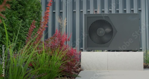 The heat pump for heating the pool is mounted on site. Ornamental plants nearby. Energy Saving Technologies. 4k video photo