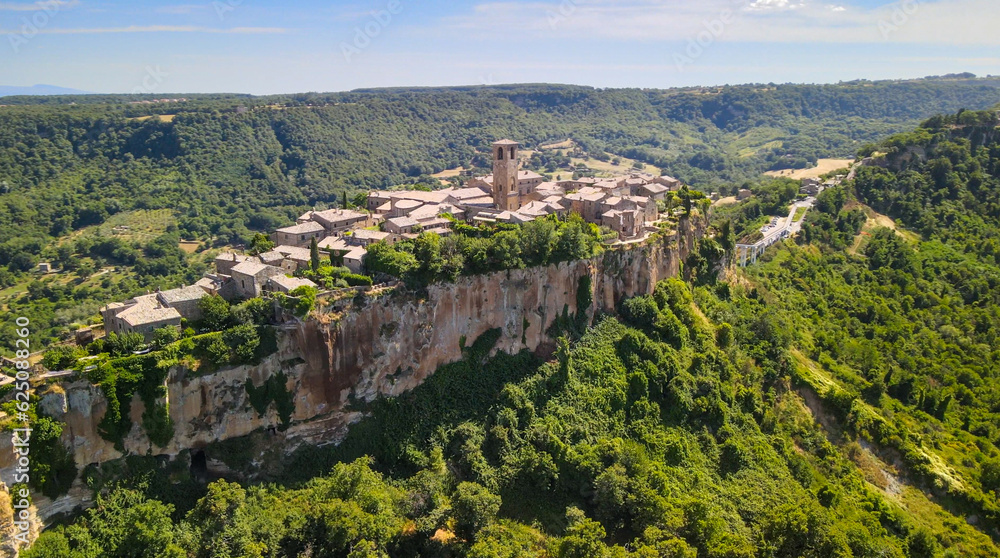 Panoramic aerial view of Civita di Bagnoregio from a flying drone around the medieval city, Italy.