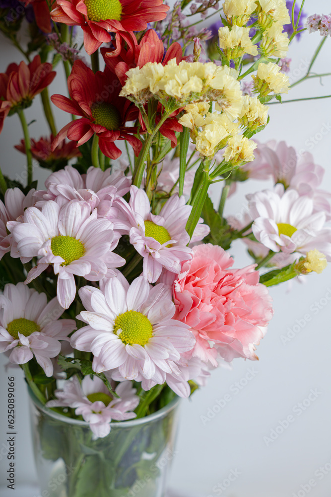 Obraz premium pink spring flowers in glass jug on white background