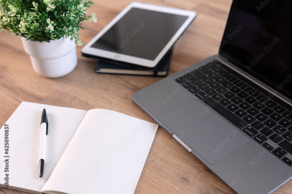 Fototapeta premium Wooden table with office supplies, top view