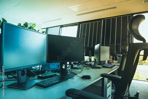 Desk with computer and monitors in the office.