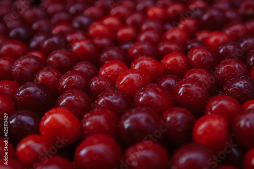 Noise, grain, out of focus, film effect background of red cherry berries with water drops close-up organic products, harvest season, vegan food, summer vitamins, culinary ingredients