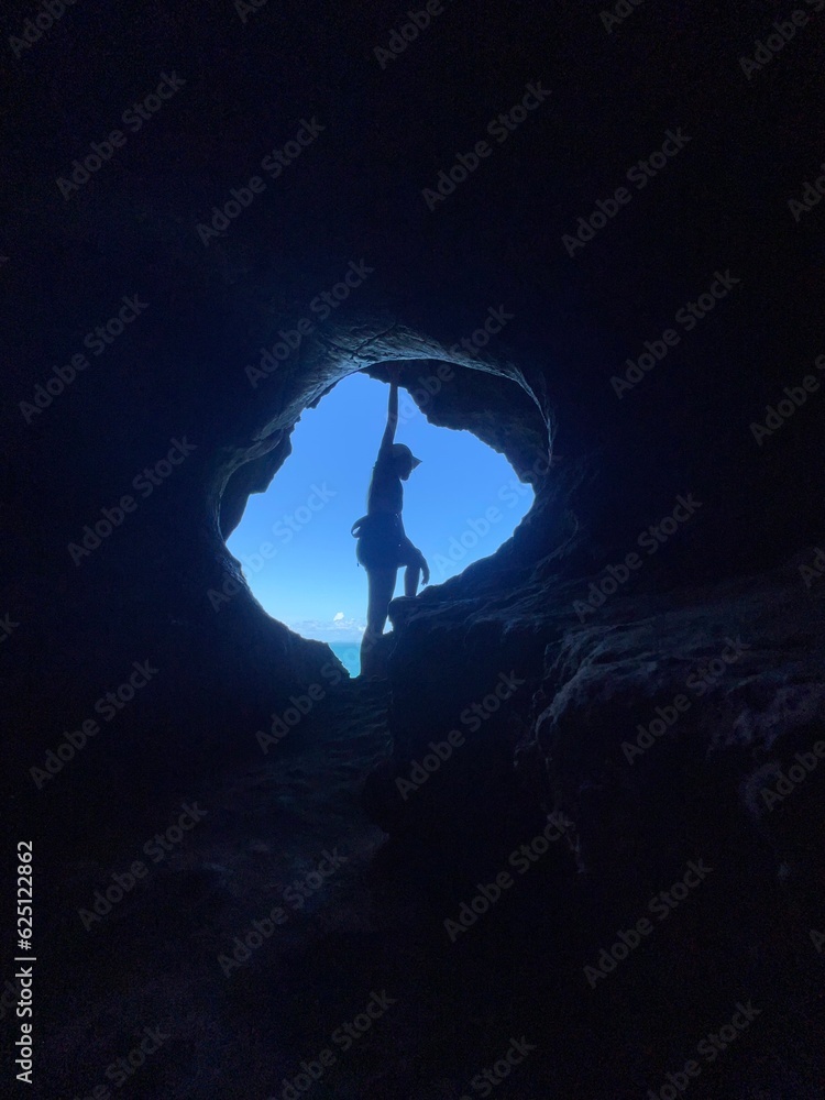 silhouette of a person in a cave