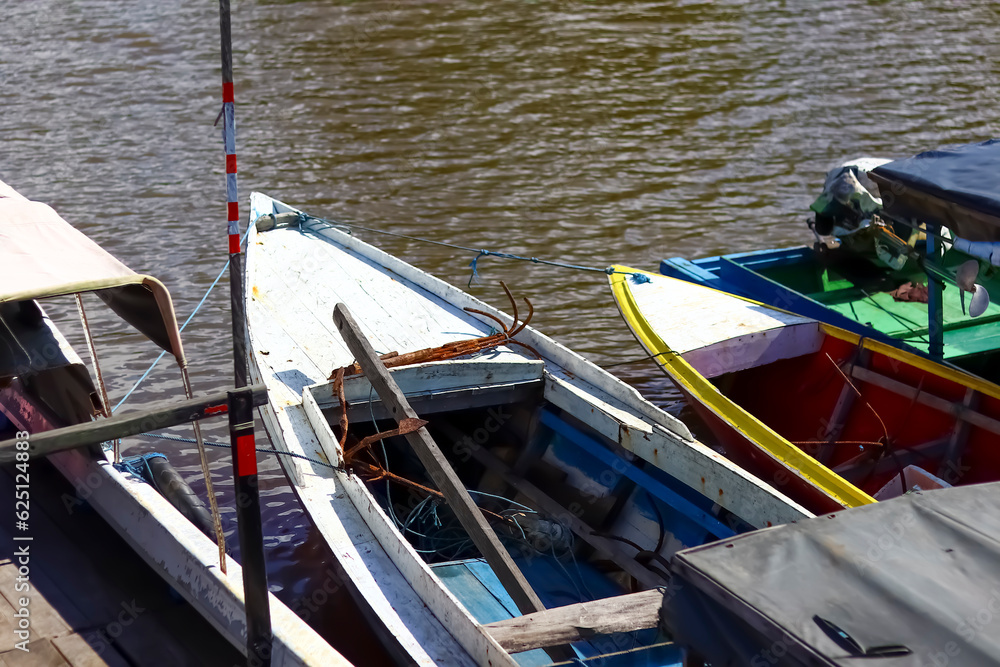 Fishing boat leaning on the coast of Kenyamukan Beach, Sangatta, East Kalimantan, Indonesia in the morning.