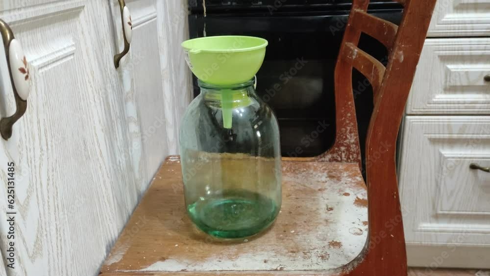 Homemade moonshine. Cooking moonshine in the kitchen. Process of distillation