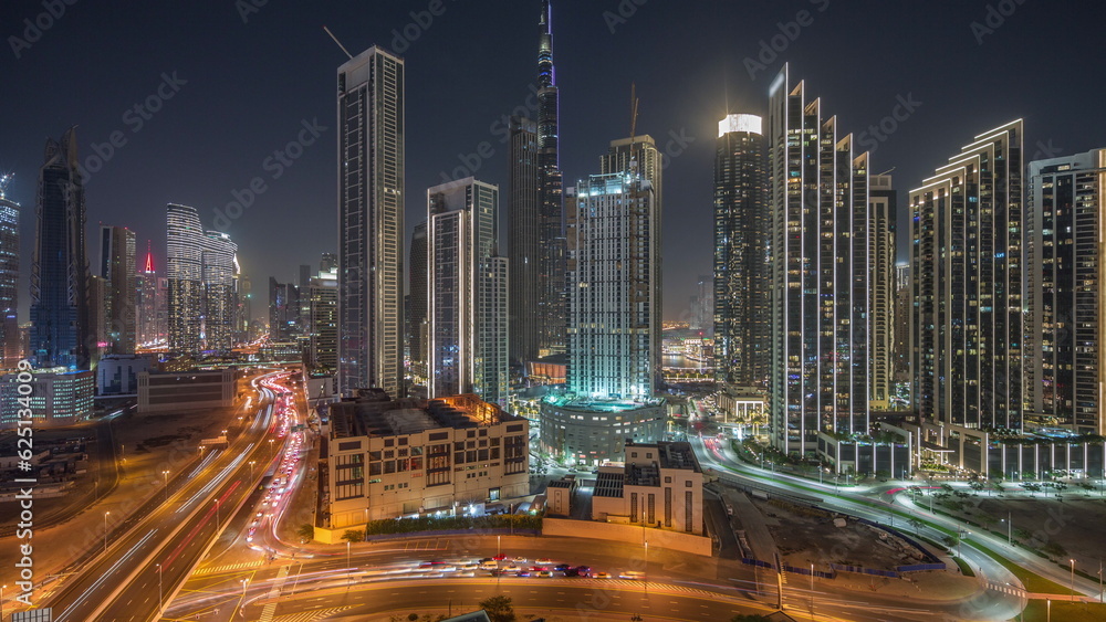 Aerial view of Dubai Downtown skyline with many towers night timelapse.