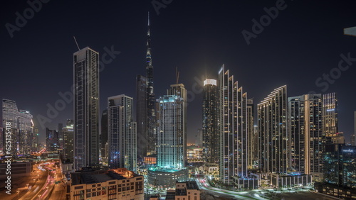Photography Aerial view of Dubai Downtown skyline with many towers night timelapse