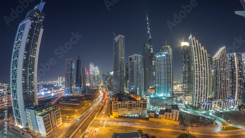 Aerial view of Dubai Downtown skyline with many towers all night timelapse.
