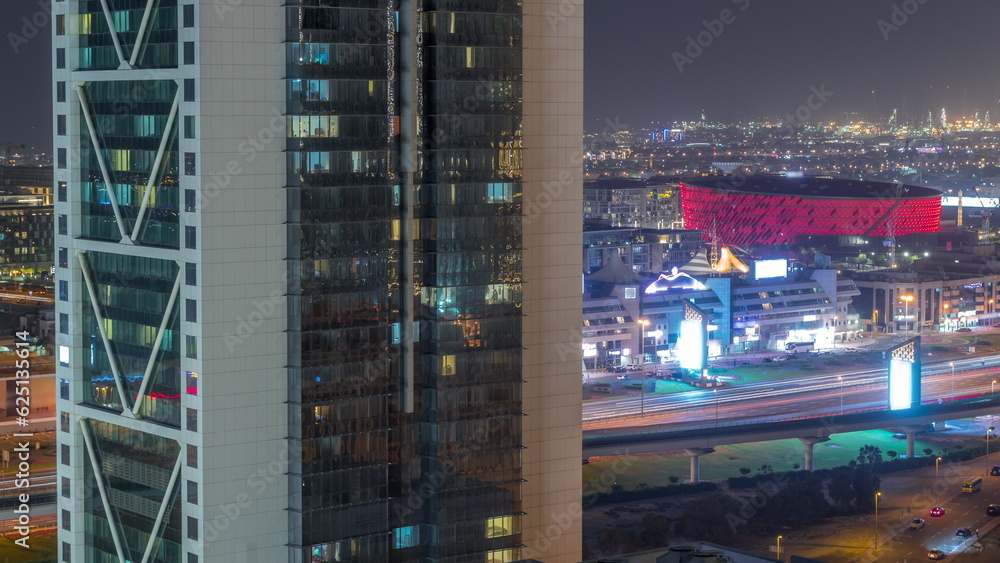 Obraz premium Aerial view to Dubai City Walk district night timelapse behind skyscraper from above