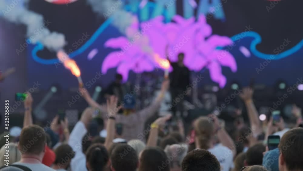 Man starting fireworks for music band during concert Man starting fireworks for music band during concert