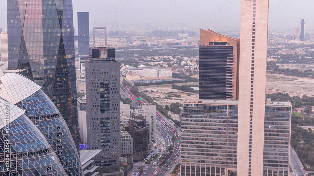 Obraz premium Skyline view of the high-rise buildings in International Financial Centre in Dubai aerial day to night timelapse, UAE.