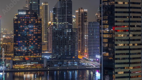 Aerial view to Dubai Business Bay and Downtown with the various skyscrapers and towers night timelapse