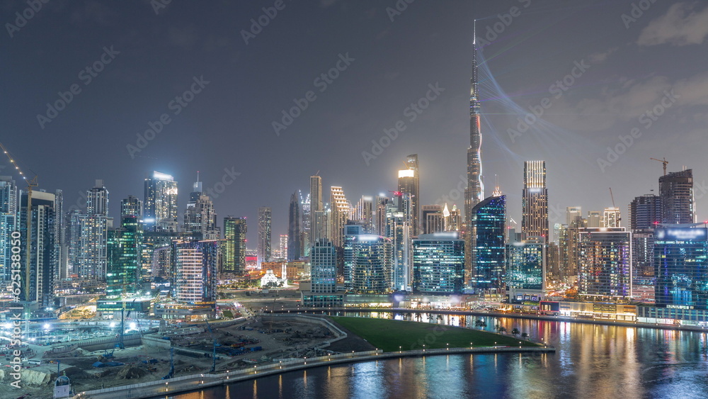 Obraz premium Aerial view to Dubai Business Bay and Downtown with the various skyscrapers and towers night timelapse