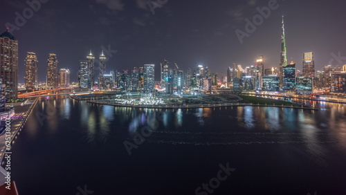 Aerial view to Dubai Business Bay and Downtown with the various skyscrapers and towers night timelapse