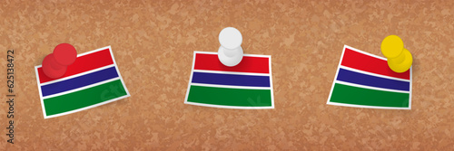 Gambia flag pinned in cork board, three versions of Gambia flag.