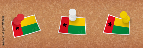 Guinea-Bissau flag pinned in cork board, three versions of Guinea-Bissau flag.