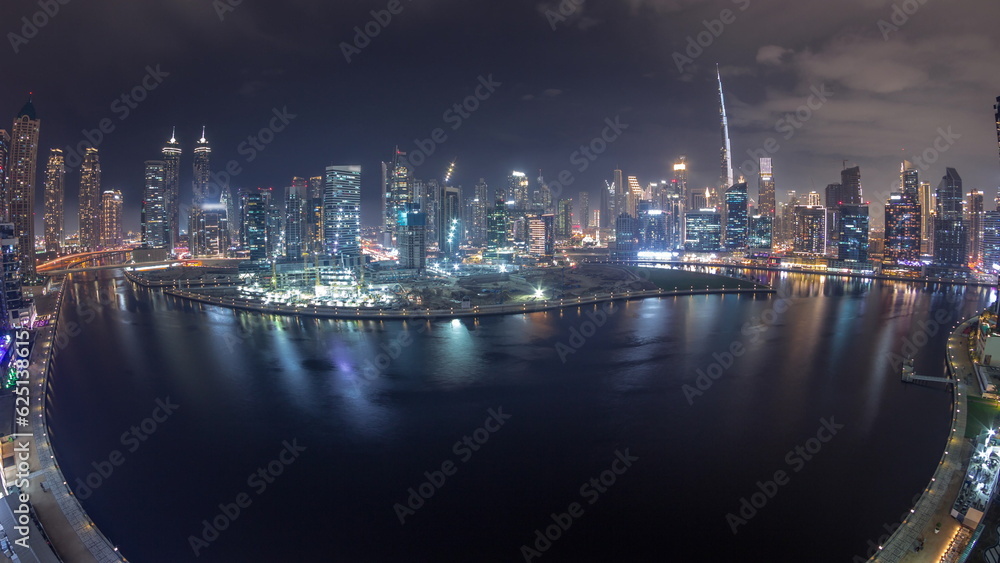 Aerial skyline panorama of Dubai Business Bay and Downtown with the various skyscrapers and towers night timelapse