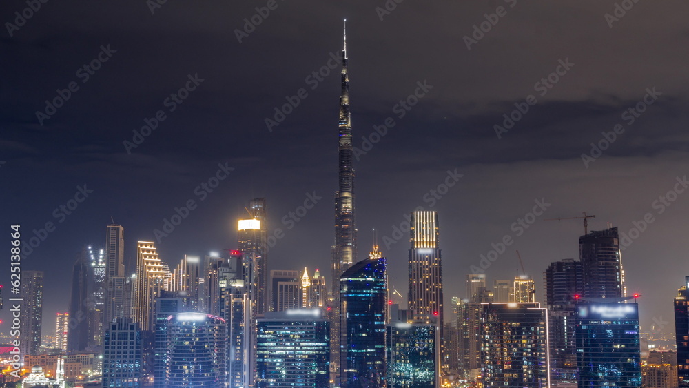 Aerial view to Dubai Business Bay and Downtown with the various skyscrapers and towers all night timelapse