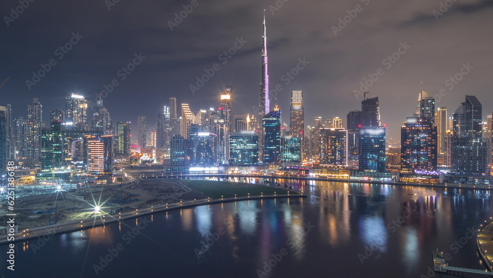 Aerial view to Dubai Business Bay and Downtown with the various skyscrapers and towers all night timelapse