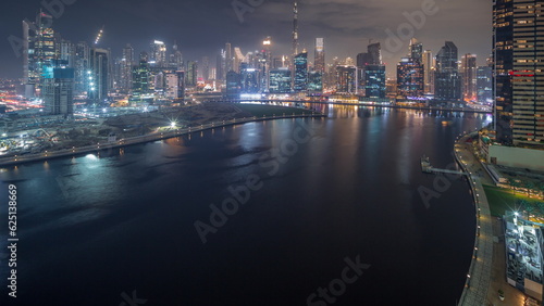 Aerial view to Dubai Business Bay and Downtown with the various skyscrapers and towers night timelapse