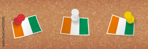 Ivory Coast flag pinned in cork board, three versions of Ivory Coast flag.