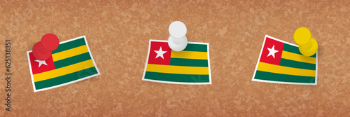 Togo flag pinned in cork board, three versions of Togo flag.
