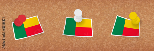 Benin flag pinned in cork board, three versions of Benin flag.