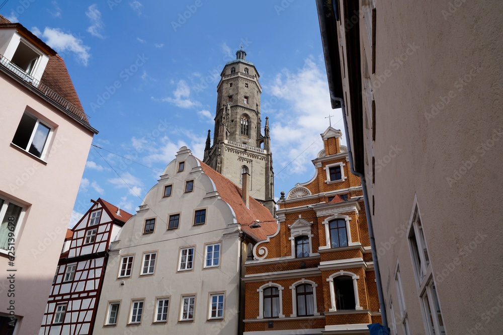 Obraz premium a beautiful ancient Bavarian town of Noerdlingen with its half-timbered houses and Saint George's Church's steeple called 