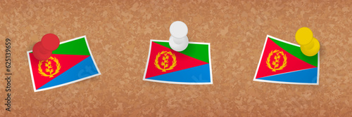 Eritrea flag pinned in cork board, three versions of Eritrea flag.