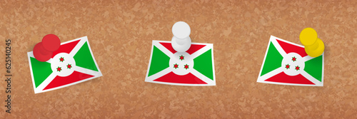Burundi flag pinned in cork board, three versions of Burundi flag.
