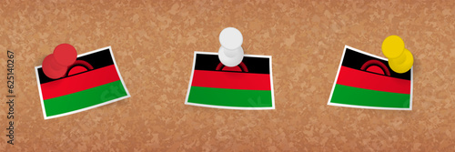 Malawi flag pinned in cork board, three versions of Malawi flag.