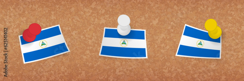 Nicaragua flag pinned in cork board, three versions of Nicaragua flag.