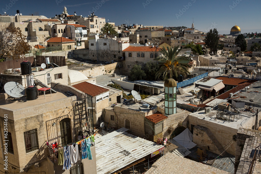 Panoramic aerial view of the Old City of Jerusalem rooftop terraces, with the Dome of the Rock in the background