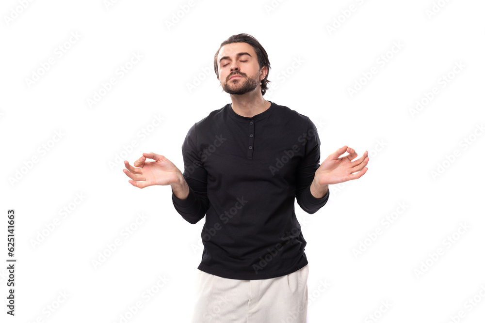 handsome young 30 year old guy with a beard dressed casually meditates handsome young 30 year old guy with a beard dressed casually meditates