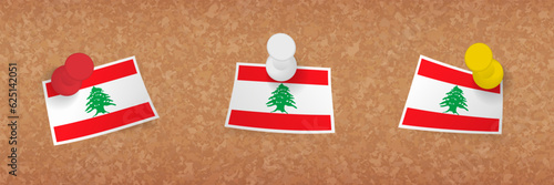 Lebanon flag pinned in cork board, three versions of Lebanon flag.