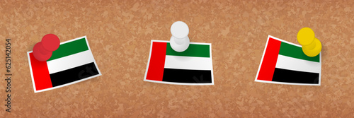 United Arab Emirates flag pinned in cork board, three versions of United Arab Emirates flag.