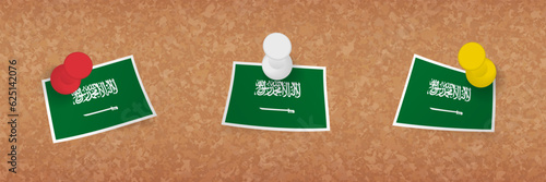 Saudi Arabia flag pinned in cork board, three versions of Saudi Arabia flag.