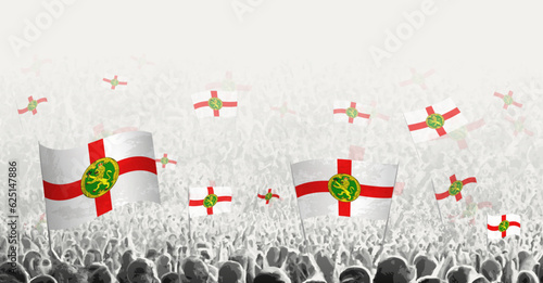 Abstract crowd with flag of Alderney. Peoples protest, revolution, strike and demonstration with flag of Alderney.