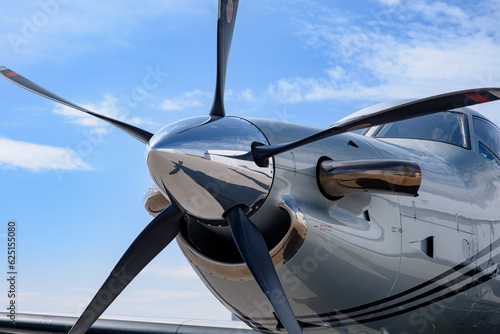 Detail of the nose cone, blades, spinner, intake, and exhaust of a turboprop Pilatus PC-12. 