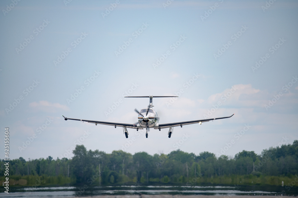 A Pilatus PC-12 taking off from a regional airport in Canada A Pilatus PC-12 taking off from a regional airport in Canada