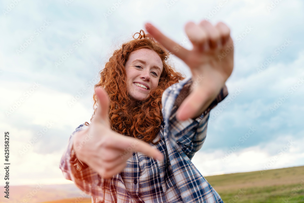 Happy woman traveler in a white jacket and backpack traveling mountains in Peak District and taking photos by phone. Local tourism lifestyle concept. Happy woman traveler in a white jacket and backpack traveling mountains in Peak District and taking photos by phone. Local tourism lifestyle concept.