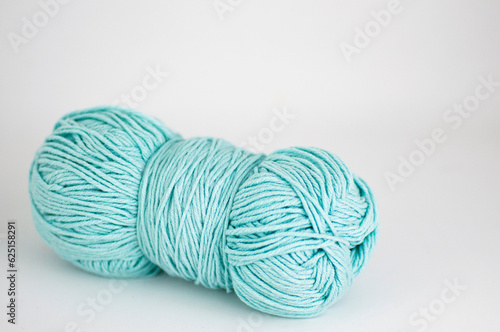 Ball of blue yarn on a white background