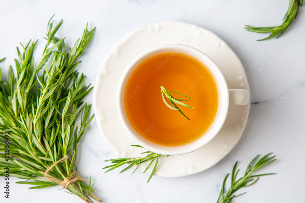 Cup of healthy rosemary tea with fresh rosemary bunch on rustic background, winter herbal hot drink concept, salvia rosmarinus Cup of healthy rosemary tea with fresh rosemary bunch on rustic background, winter herbal hot drink concept, salvia rosmarinus