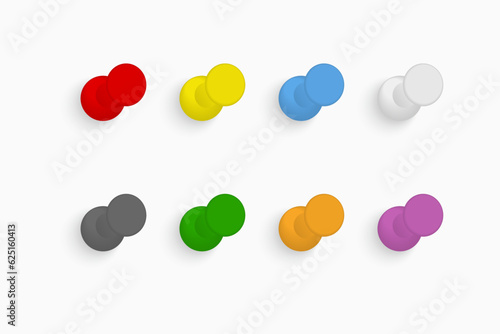 Colorful push pins set on light background.