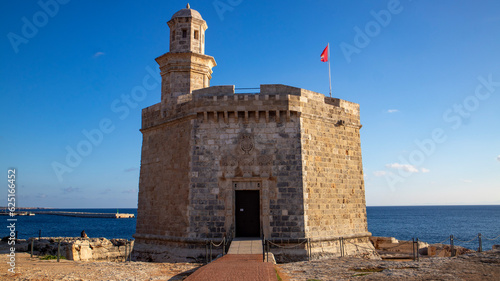 Sant Nicolau Castle in beautiful mediterranean town of Ciutadella in Menorca island. The Sant Nicolau Castle is strategically located at the entrance of the Ciutadella port photo