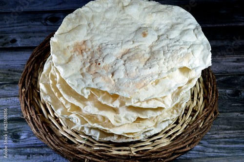Pile of Egyptian Roqaq, sort of round shaped pastry, made of flour, water and salt, becomes brittle and is usually used for porridges and pies when baked, it's cooked in different recipes with meat photo