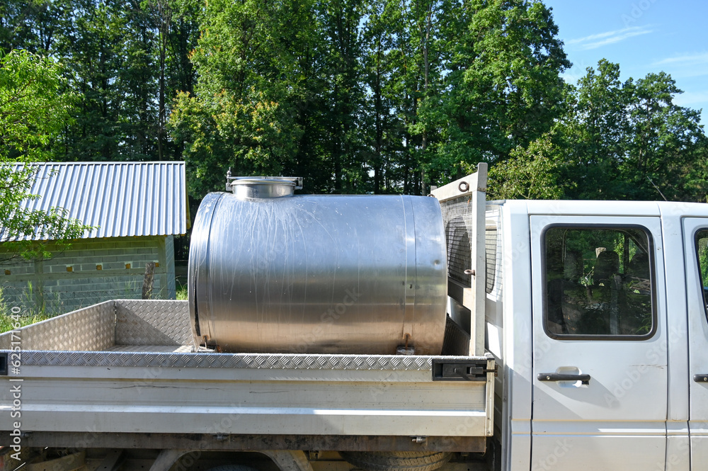 Tanker with fresh milk on a truck. Purchase of domestic milk. Dairy industry. The sale of milk from rural areas. Tanker collecting milk on farm. Tanker with fresh milk on a truck. Purchase of domestic milk. Dairy industry. The sale of milk from rural areas. Tanker collecting milk on farm.