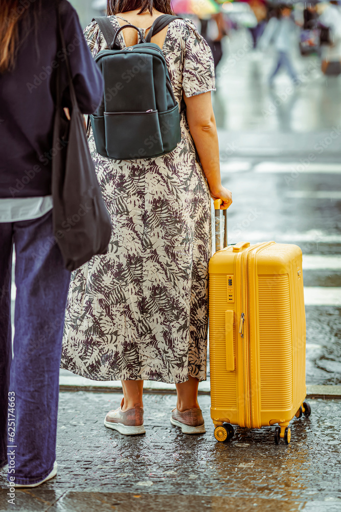Unrecognizable girl traveling with suitcase, travel and tourism