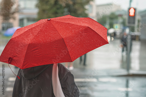 Fotografiet Abstract girl under red umbrella, modern city, rainy evening